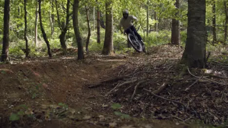 Man On Mountain Bike Cycling Along Dirt Trail Through Woodland At Speed 2