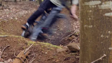 Close Up Of Man On Mountain Bike Cycling Along Dirt Trail Through Woodland