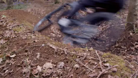 Close Up Of Man On Mountain Bike Cycling At Speed Along Dirt Trail Through Woodland