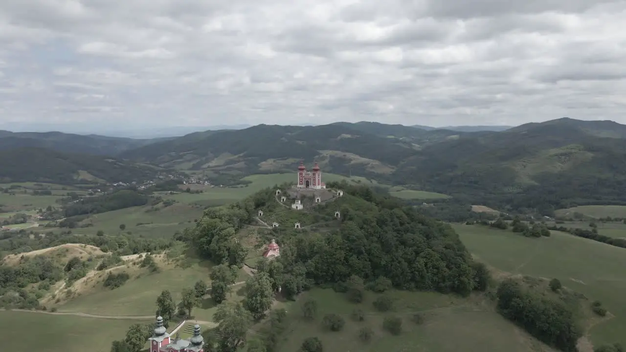 Small chapel on the top of the hill surrounded by mountains in Slovakia during cloudy day