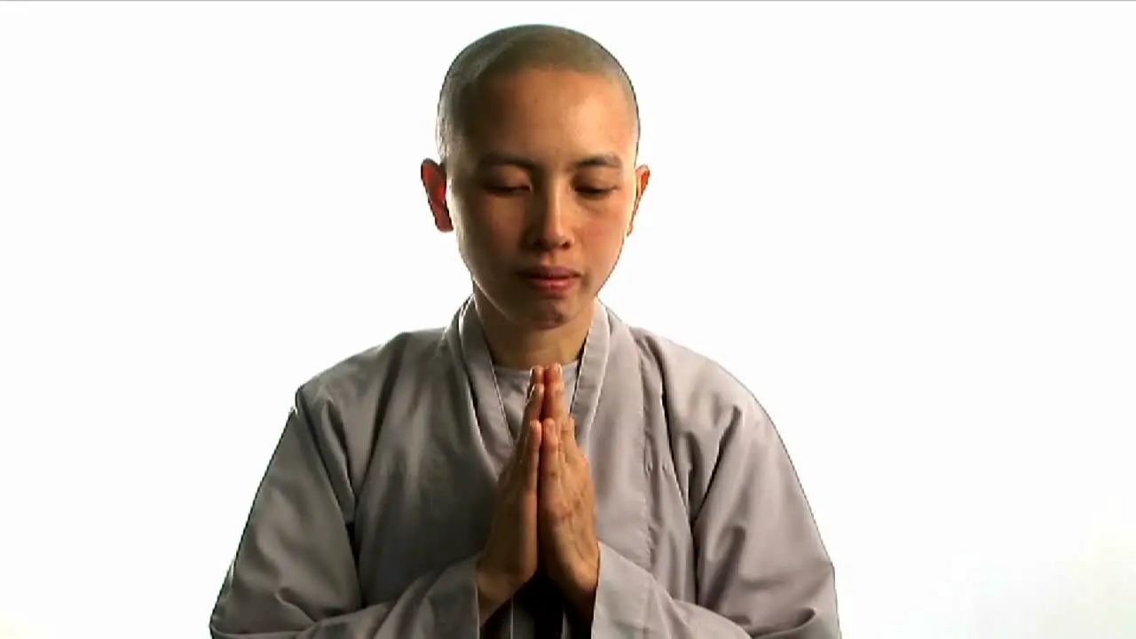 A young Buddhist monk prays