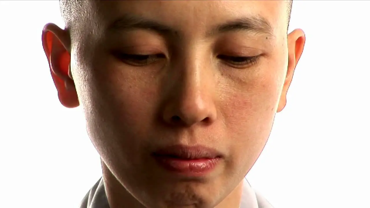 A young Buddhist monk prays 1