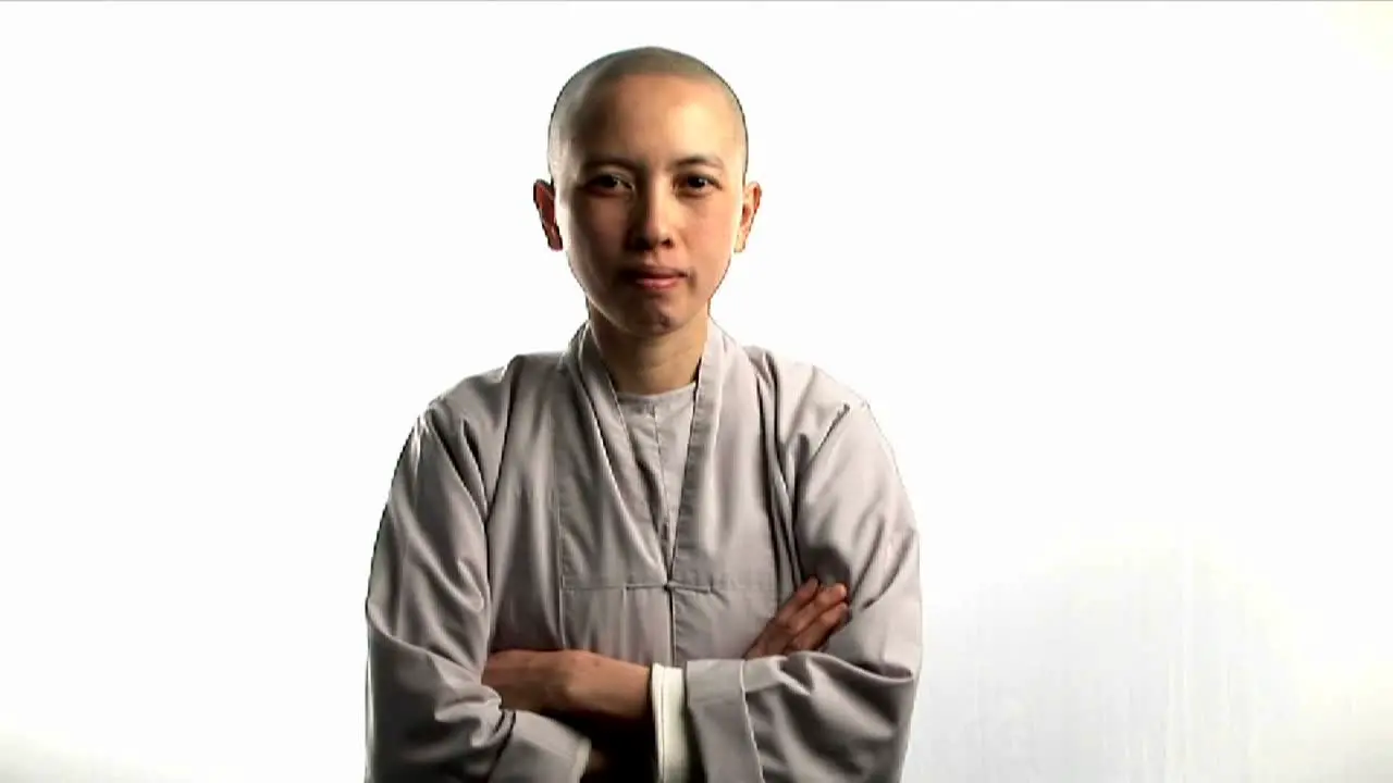 A young Buddhist monk laughs