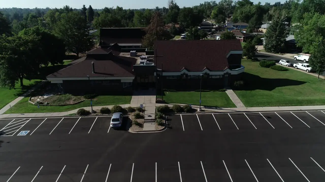 Suburban Christian church flyover with an empty parking lot summer 2022