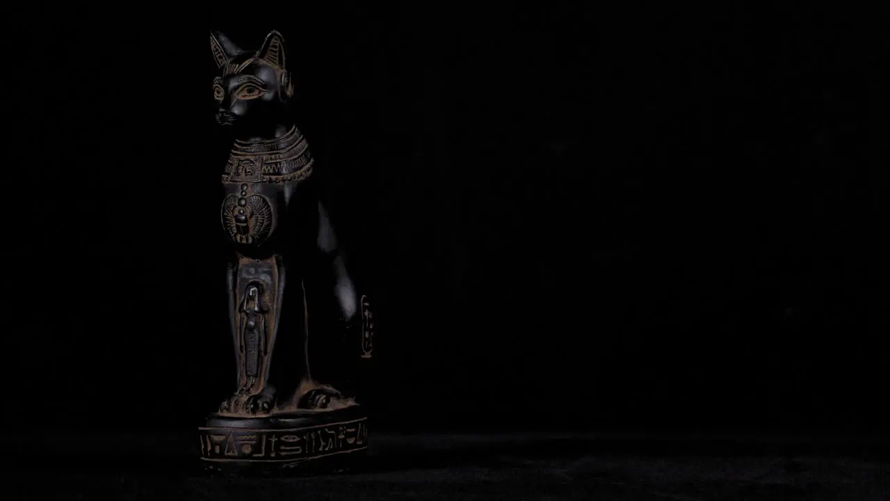 Dolly of a small replica Egyptian Statue of Bastet Wide Left to Right