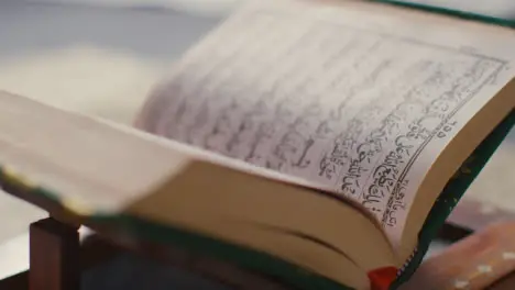 Close Up Of Open Copy Of The Quran On Stand At Home 5