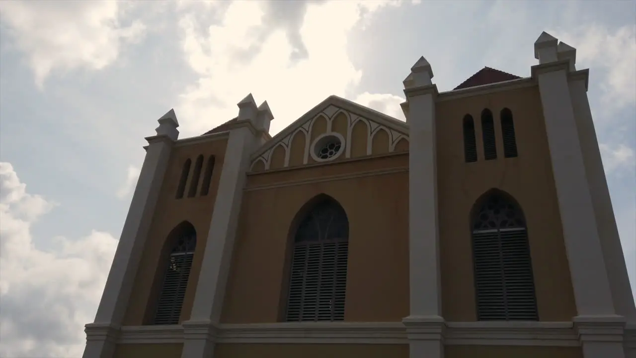 Clouds moving over a church in the early morning