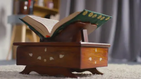 Close Up Of Open Copy Of The Quran On Stand At Home 4