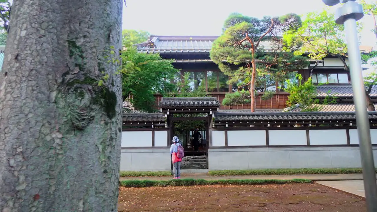 Two people talking quietly at the exit of a temple in Tokyo Japan