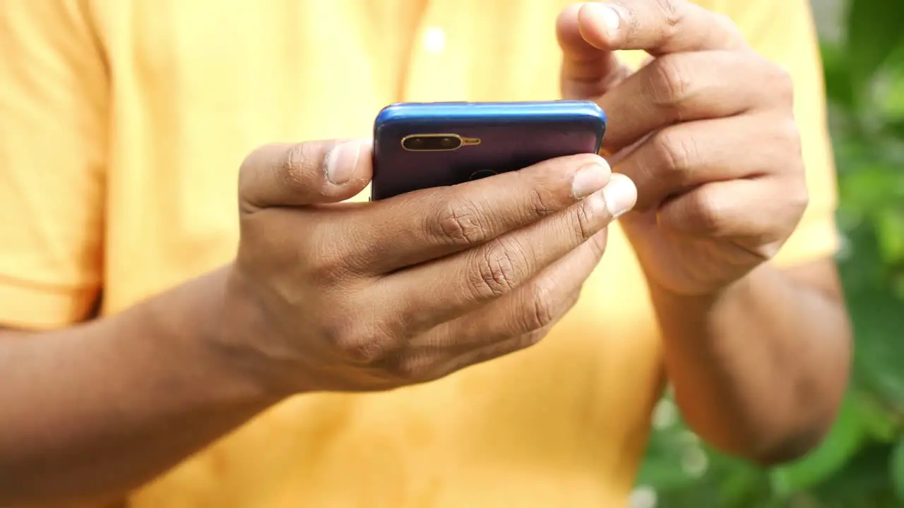 Young men in yellow shirt using smart phone 