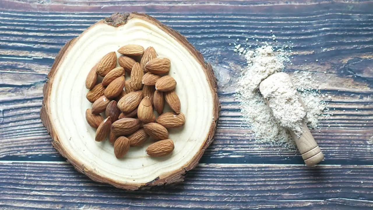 Almond powder and almond on table