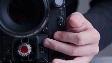 Close Up Shot of Person Hitting Record Button On RED Dragon Cinema Camera