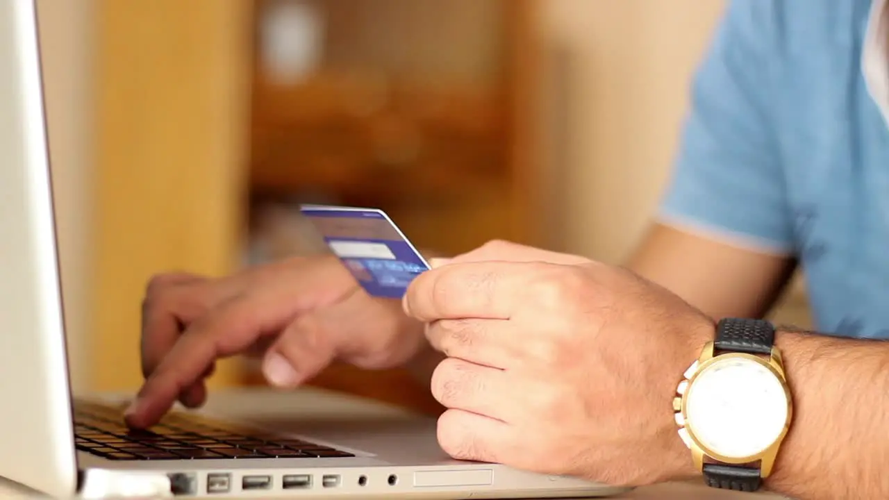 Close Up Of Man Shopping Online Using Laptop With Credit Card 1