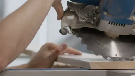 Close Up Shot of Carpenters Hands Lining Up Circular Saw On Skirting Board