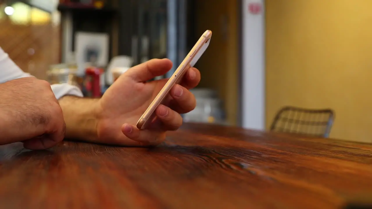 Man Using Phone In Restaurant