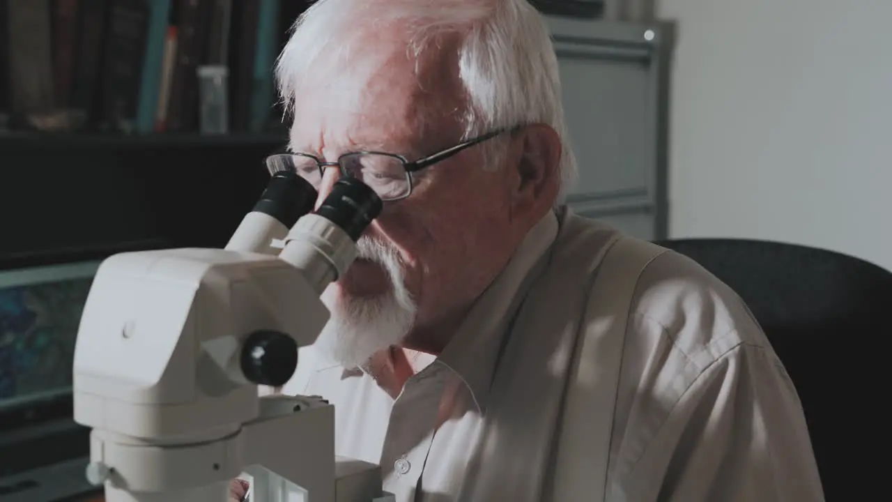 Male scientist looking into a microscope