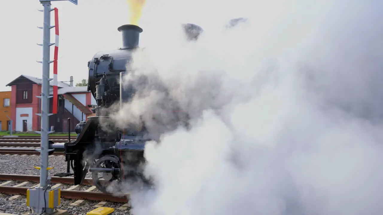 Black historical locomotive moving away