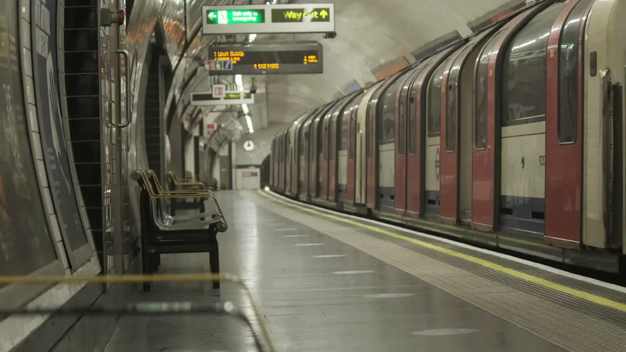 London Central Line tube train leaving an empty station