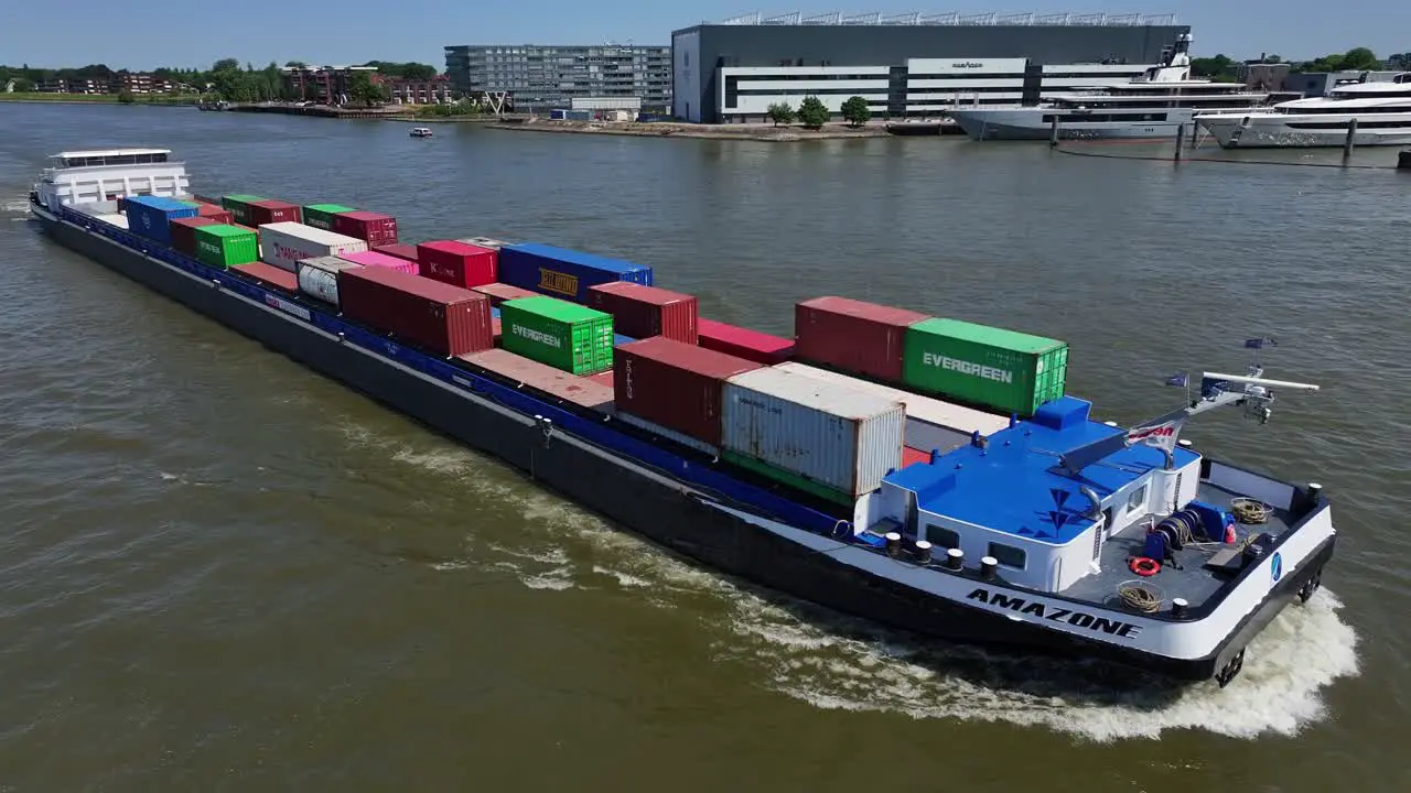 Aerial view of a cargo container ship carrying cargo on the river in Alblasserdam in South Holland