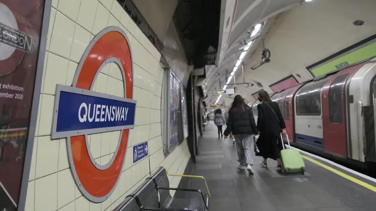 London underground Central Line train leaving Queensway tube station