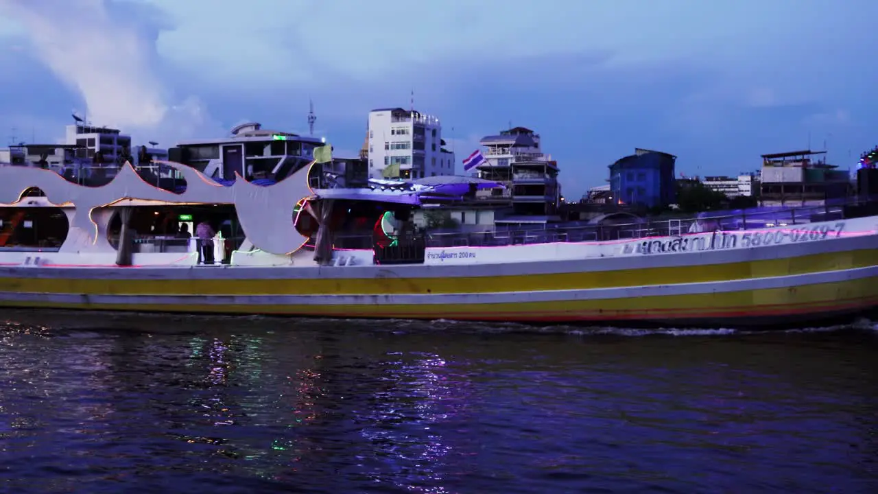 Tourist ferry on the Chao Phraya river in Bangkok at night Thailand