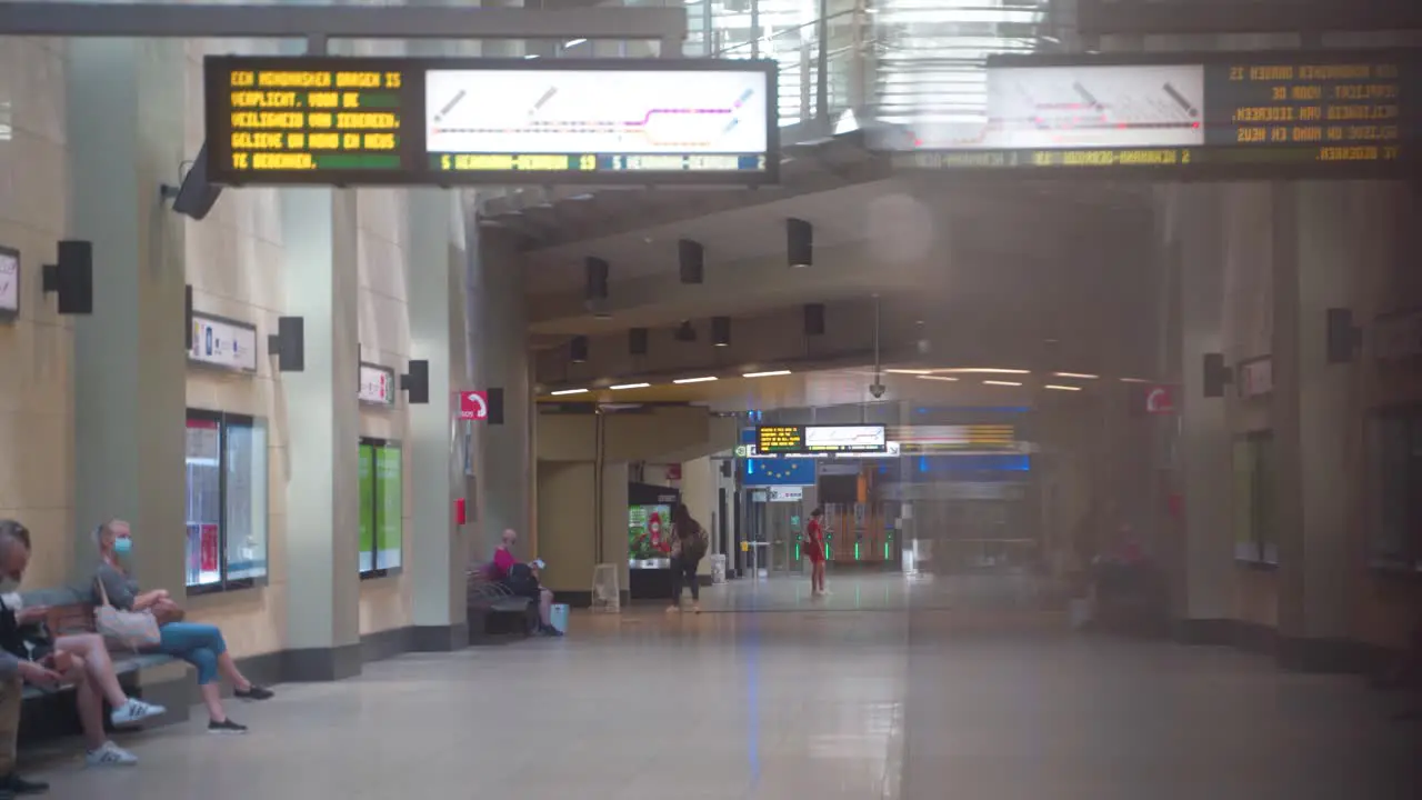 People waiting in Underground Station for the Metro Subway train to arrive in Brussels Belgium at the Bruxelles-Schuman metro railway station during covid pandemic in 2020