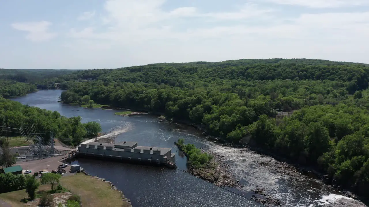 Rising and panning aerial shot above the Saint Croix Falls Hydro-Electric Dam in Wisconsin