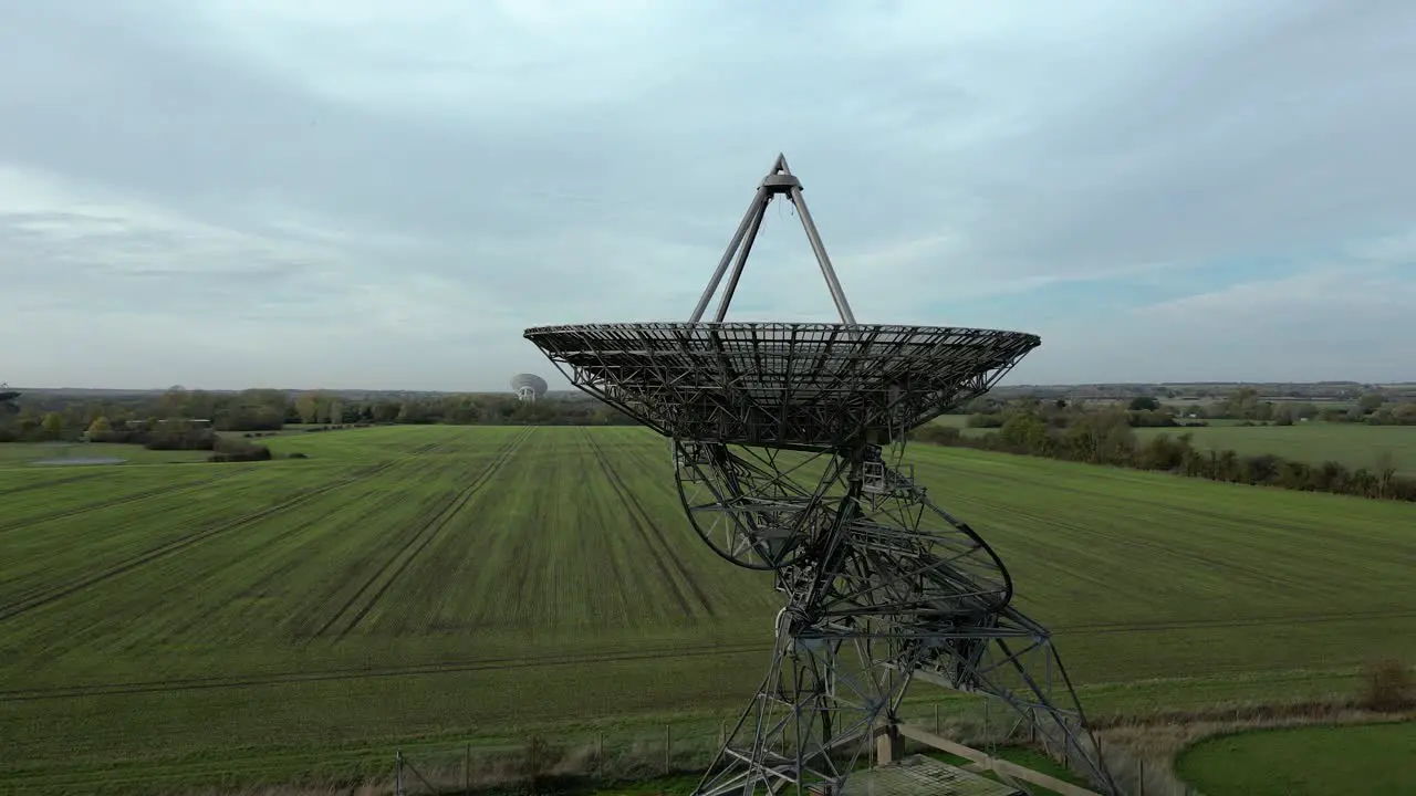 Aerial ascending orbit shot of the radiotelescope antenna at MRAO Cambridge UK