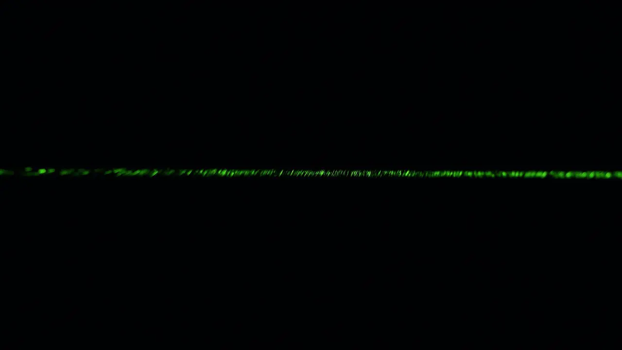 Dust particles in green laser light beam from diffraction grating