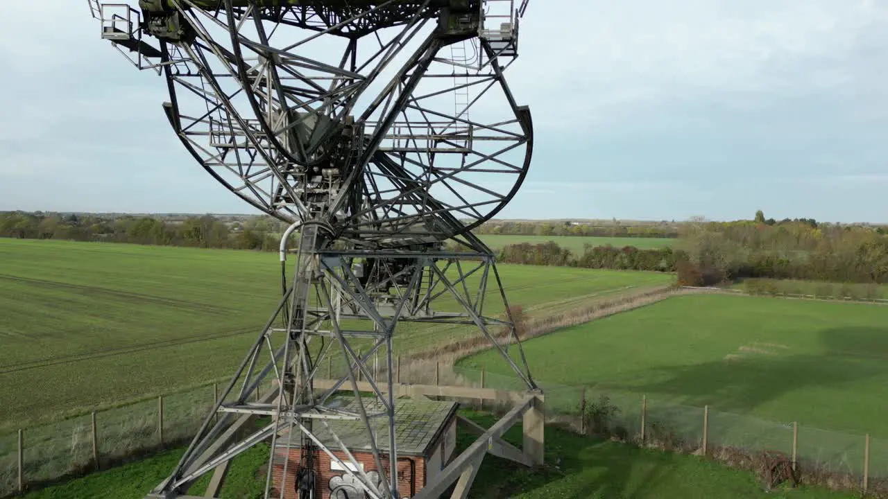 Aerial ascending shot of the modern radiotelescope antenna at the Mullard Radio Astronomy Observatory