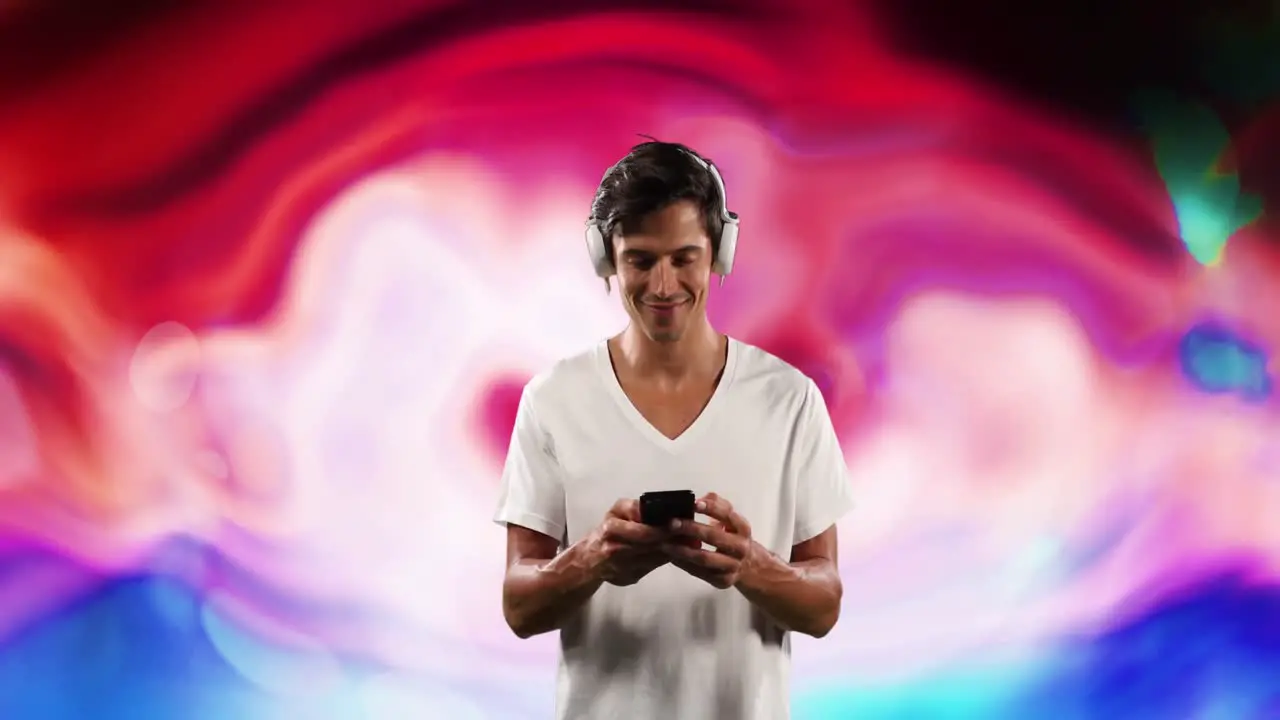 Animation of caucasian man with smartphone and headphones over colorful background