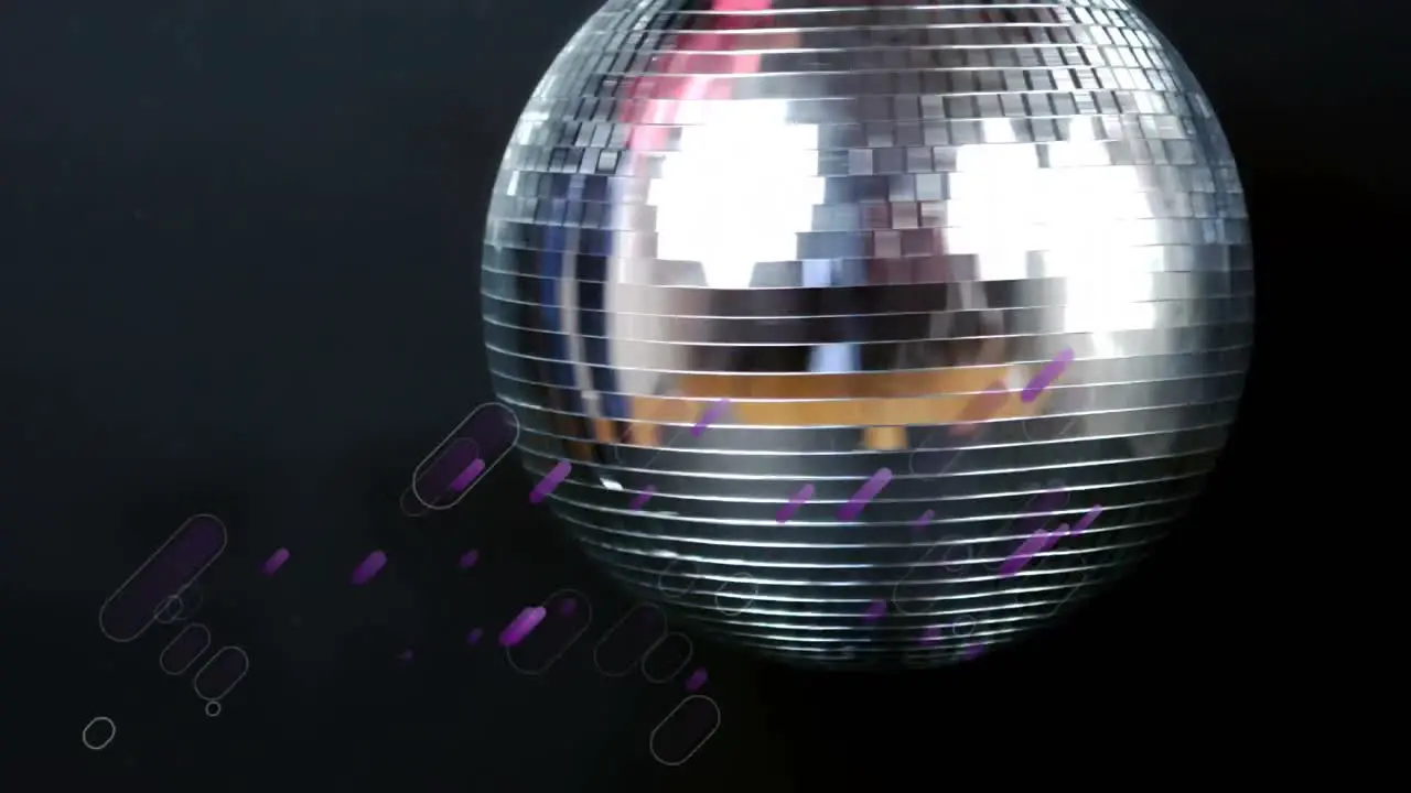 Animation of purple light trails over spinning mirror disco ball