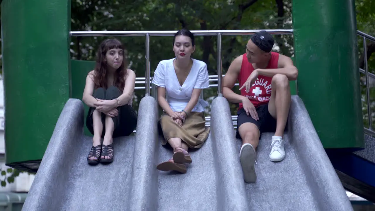 3 young adults chatting in the playground