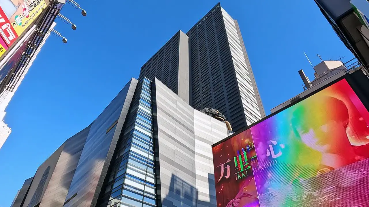 looking up the skycrapers with billabords in Shinjuku