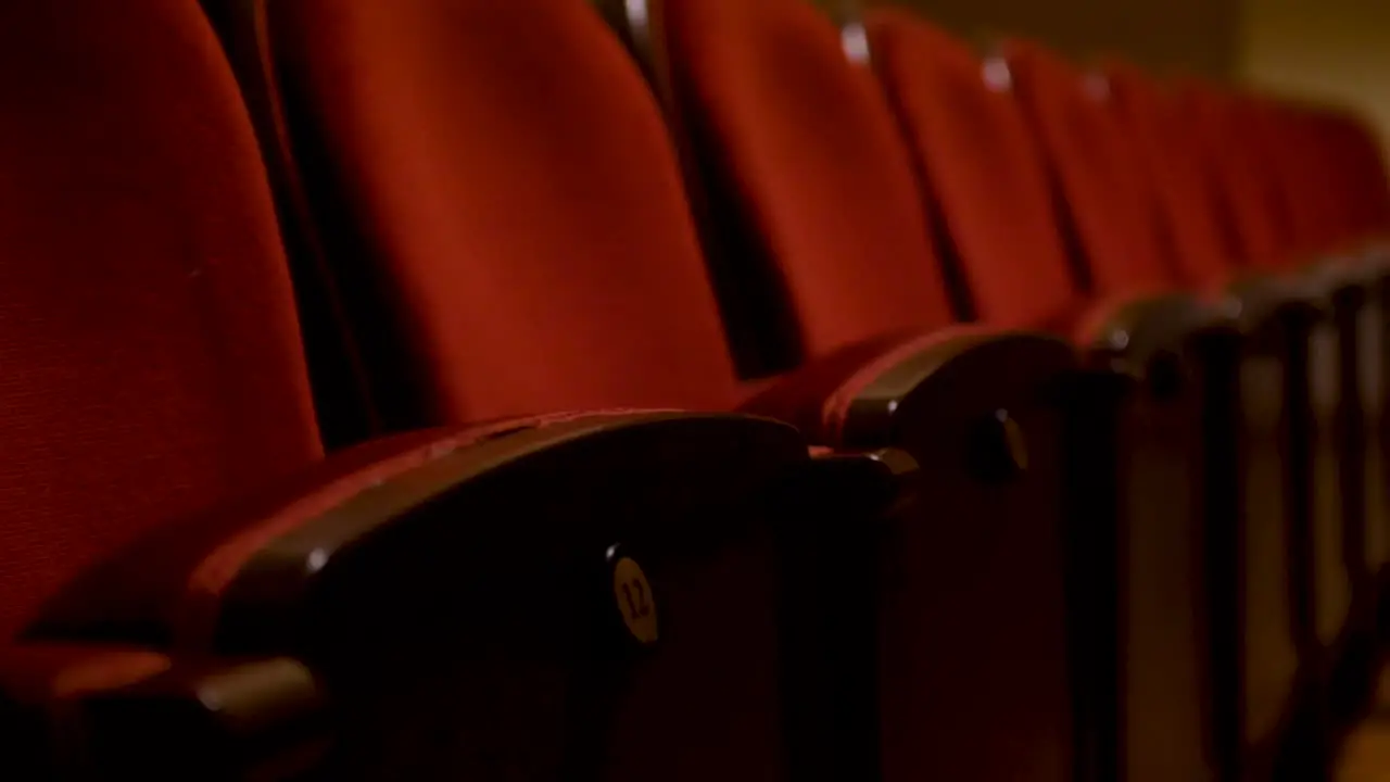 Pulling focus on one theatre seat in row of empty seats