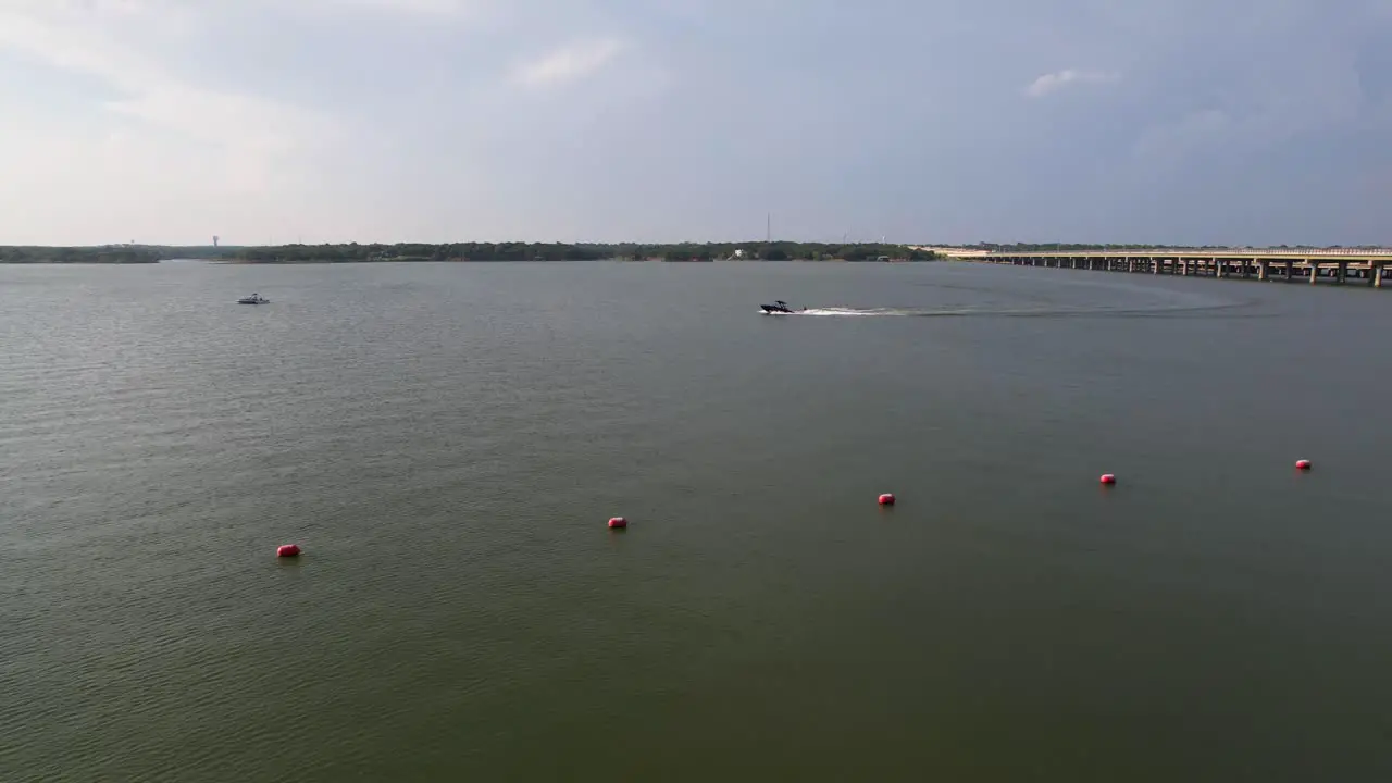 This is an aerial video of a boat with a skier on Lake Lewisville near Copperas Branch Park