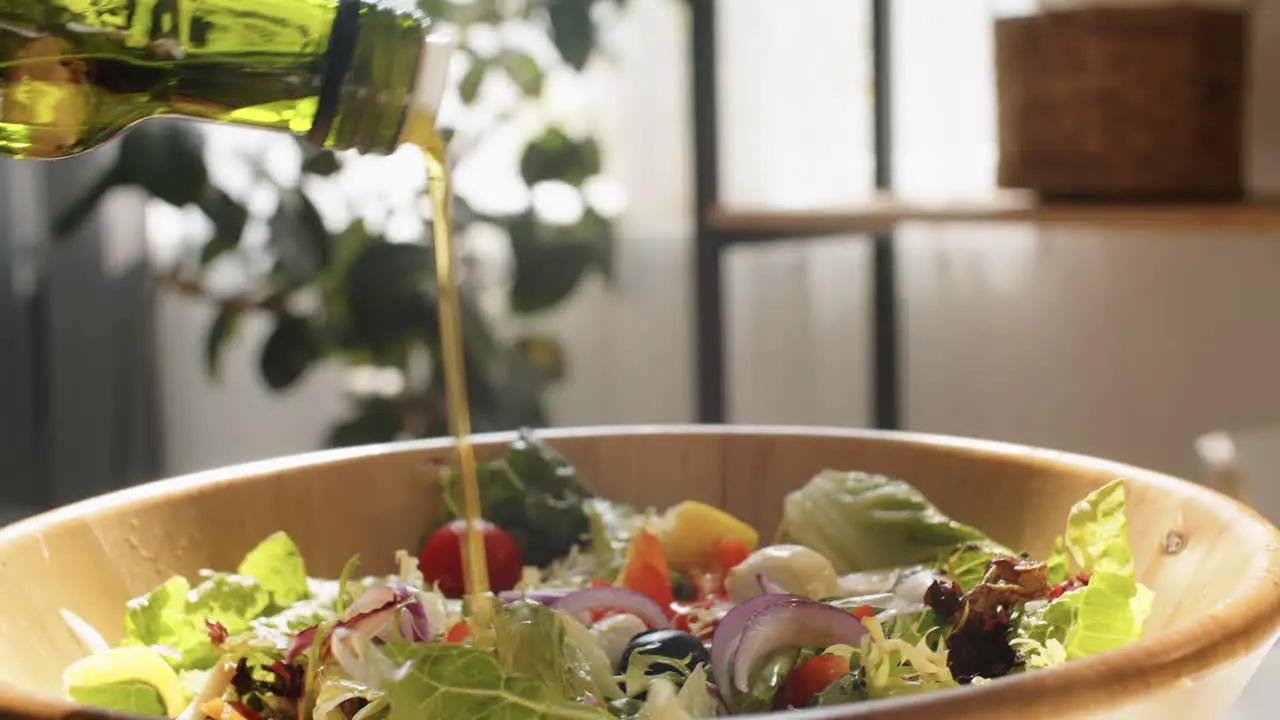 Adding Olive Oil to Salad in Bowl