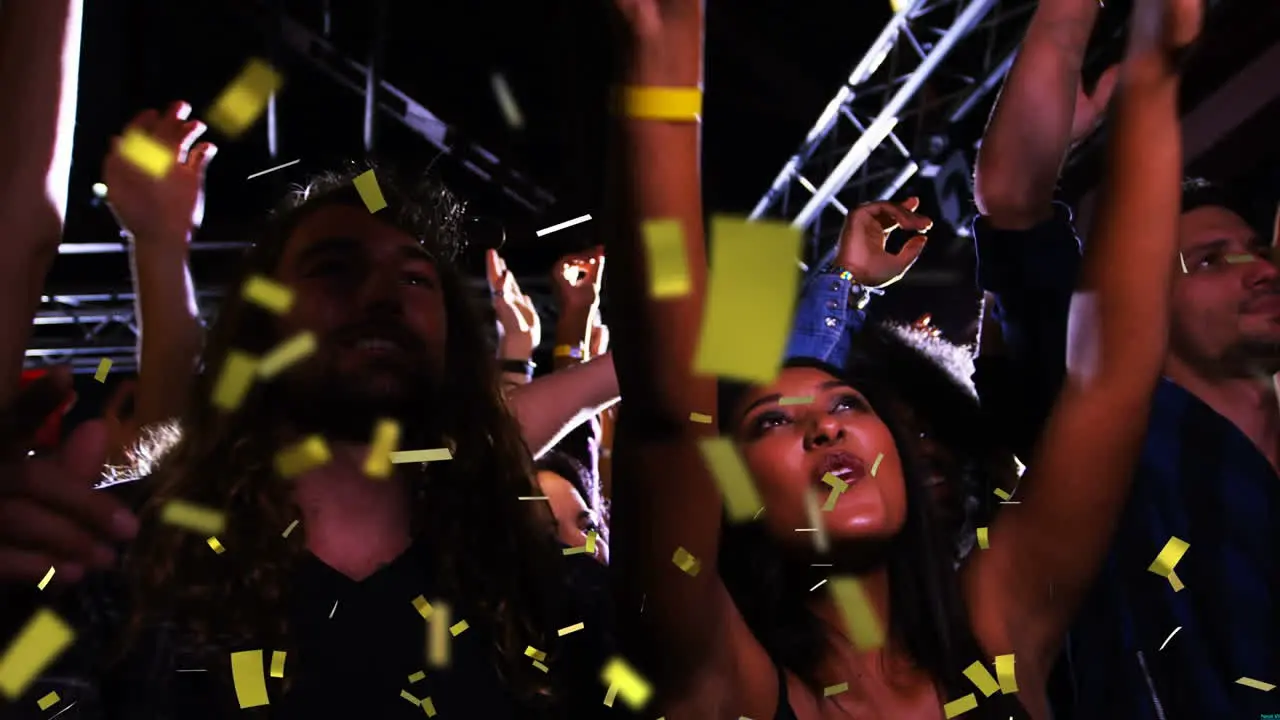 Animation of gold confetti falling over happy people dancing outdoors