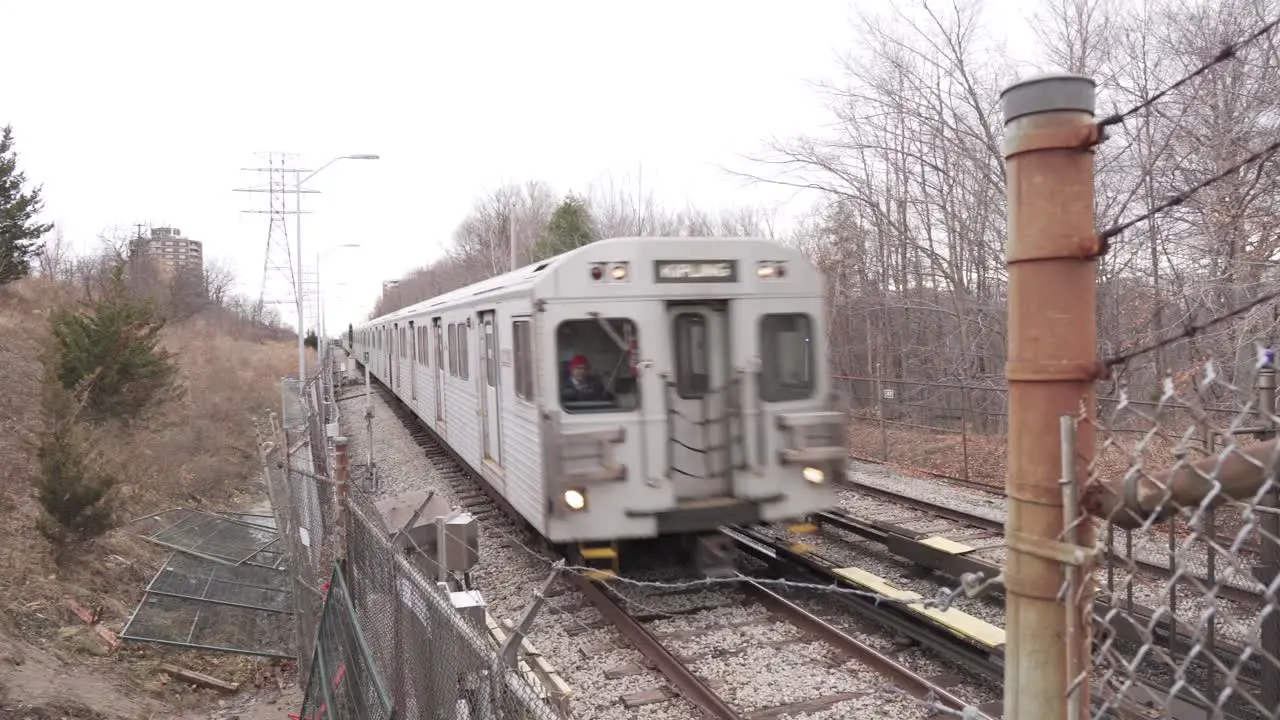 Cinematic Ground View of Metropolitan Train during an overcast winter day