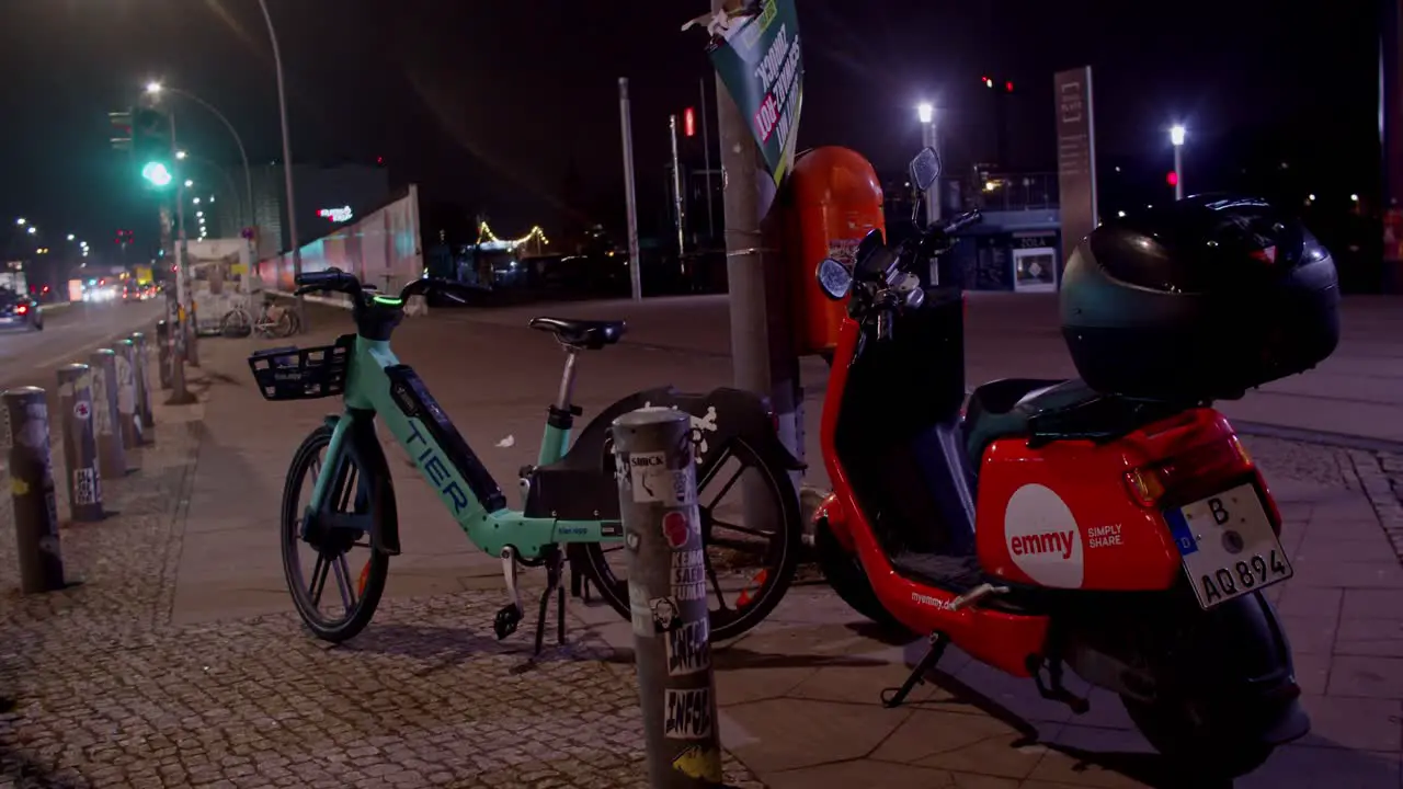 Establishing shot of electric bike and scooter Berlin circle pan night