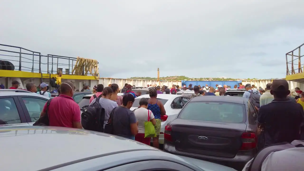 Ferry boat filled with cars people wait for the gates to open