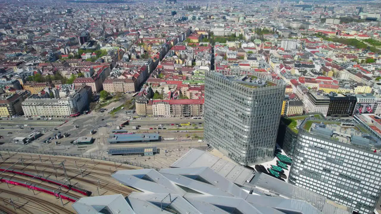 Aerial establishing shot of Vienna train station as trains come and go