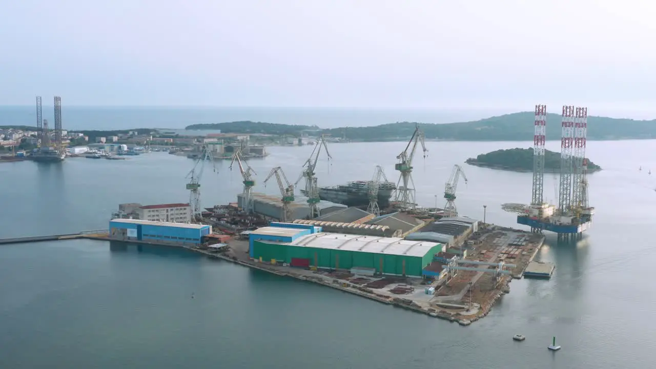 Harbour of pula with big cranes and platforms from the air