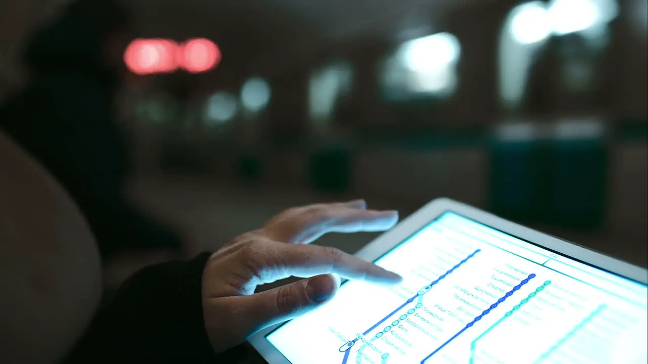 Woman looking at underground map using touch pad