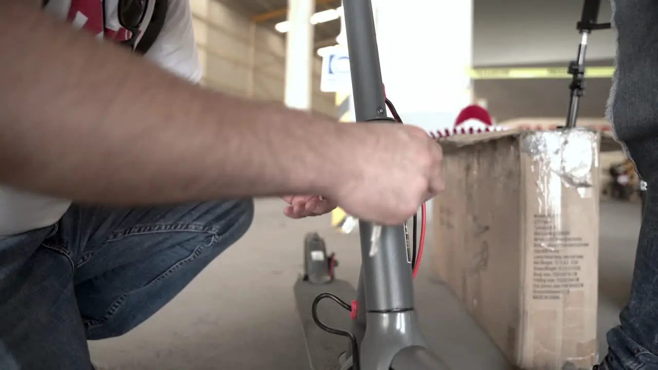 Person working on an electric scooter at the shop