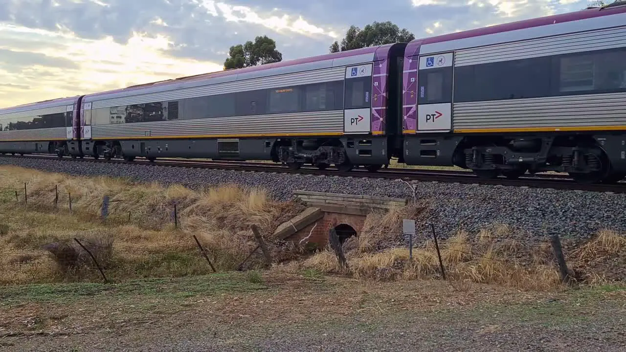 A Vline country train moving through a railway crossing at Chiltern in Victoria Australia