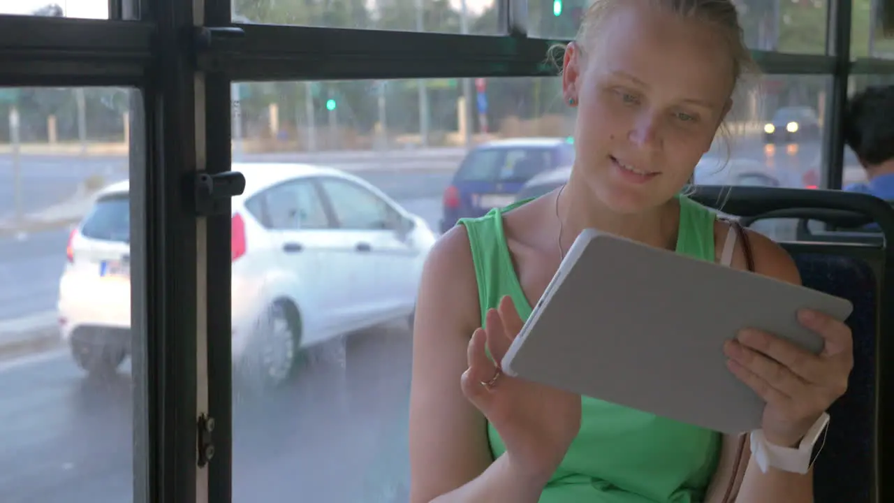 Woman using tablet in bus