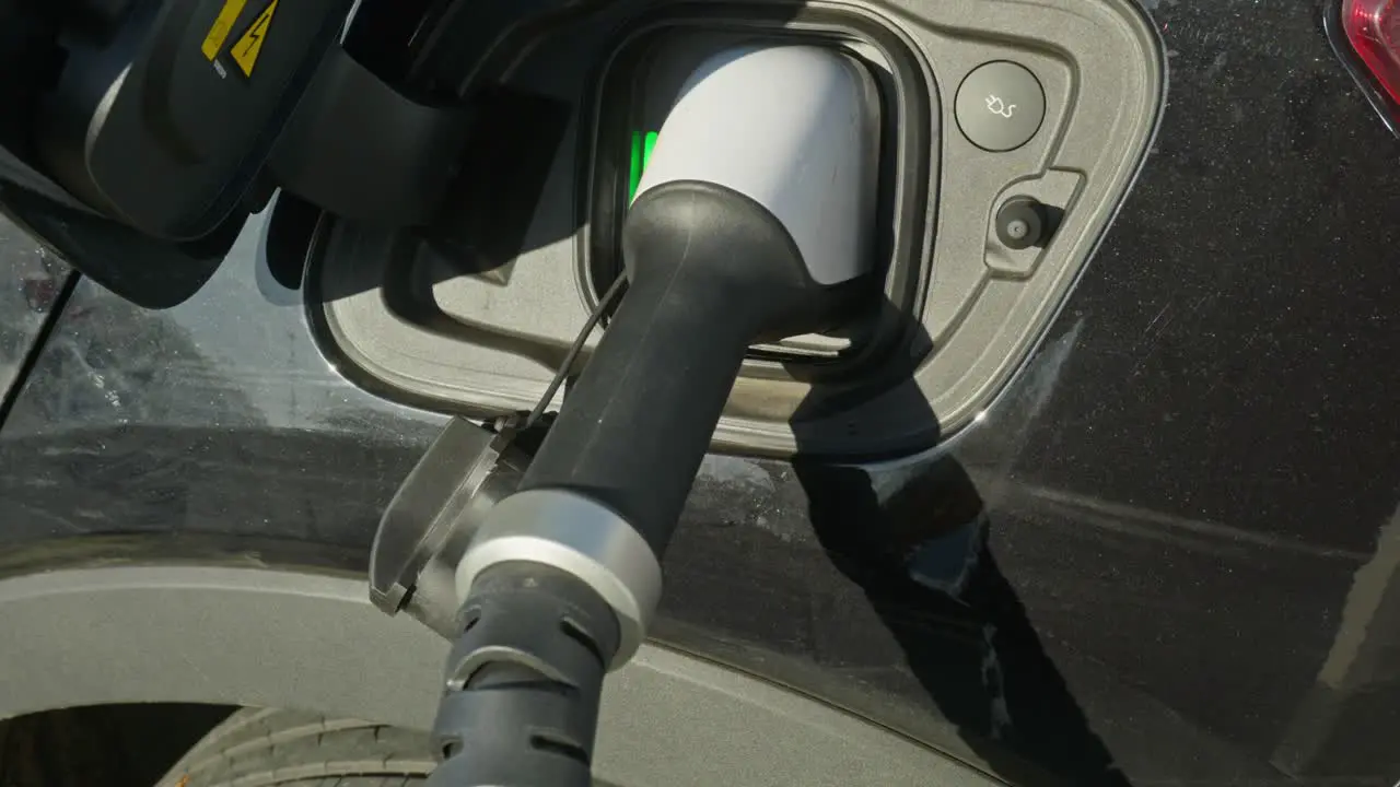 Electric EV charge cable plugged into car socket Close up shot