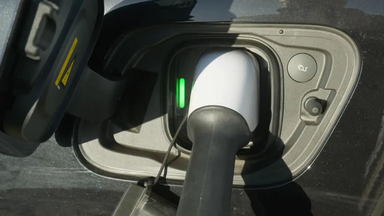 Electric EV re- charge cable plugged into car socket Close up shot