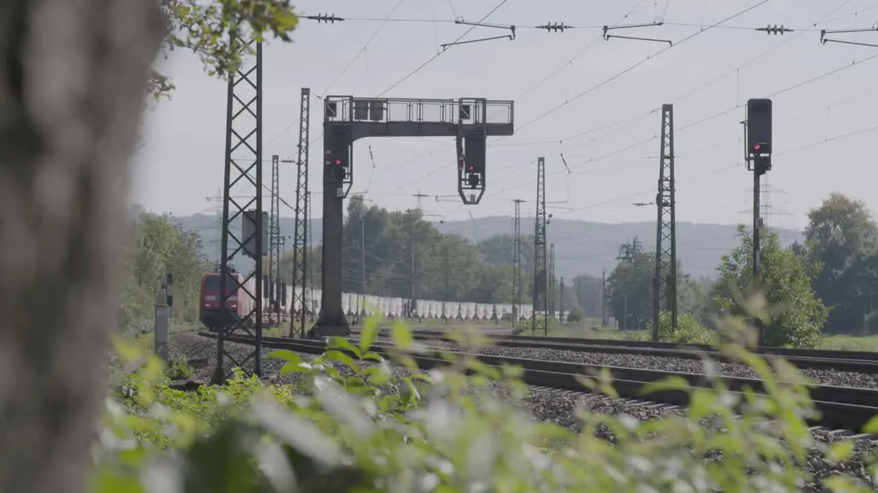 Freight train passing by with focus on the cargo containers blurred natural foreground